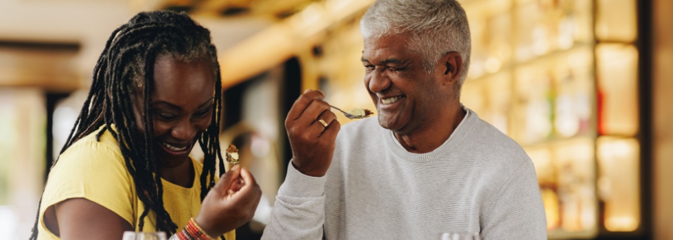 A couple laughing together at a café.