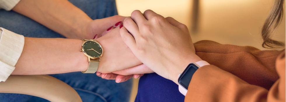 Two people clasping hands.