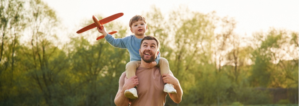 A father with a child sitting on his shoulders.