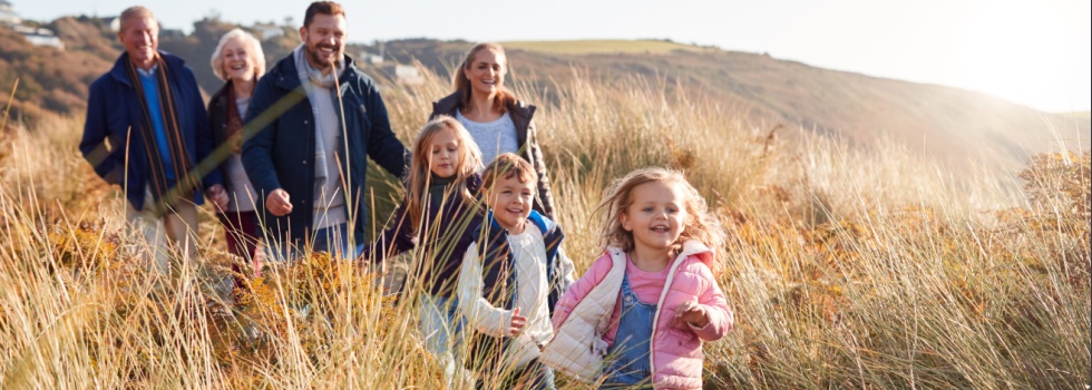 A family walking through dunes.