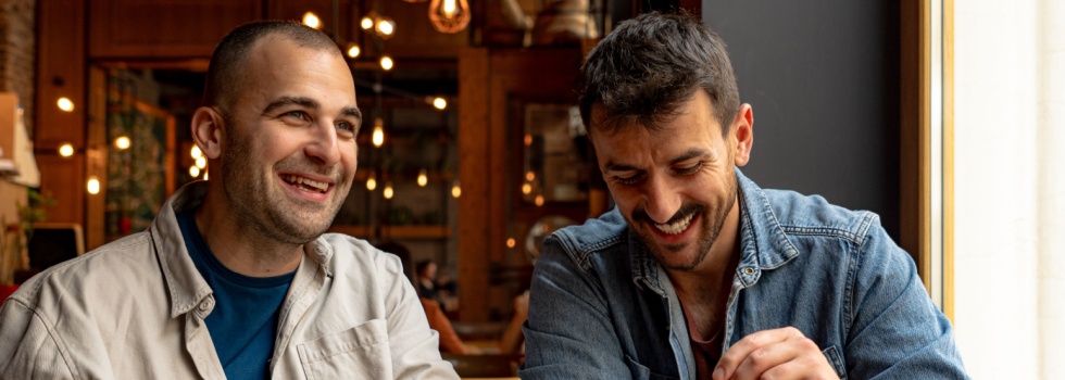 Two men talking in a café.