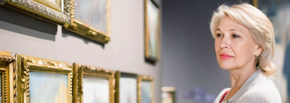 A woman looking at art in a gallery.