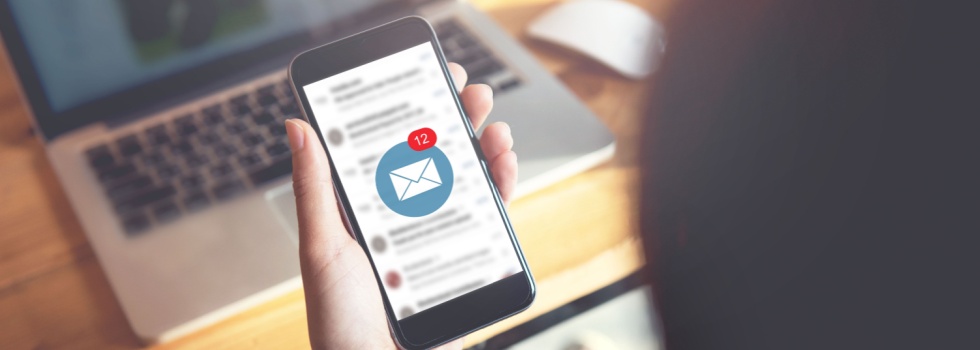 A person looking at their email on their phone.