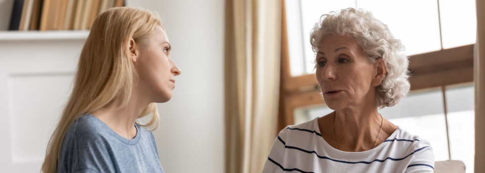 A mother and adult daughter talking.
