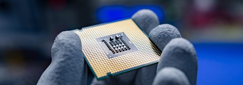 A hand holding a CPU.