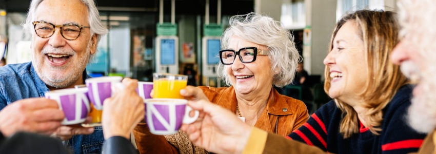 A group of people talking and drinking tea.