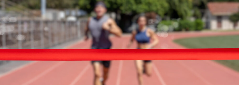 Runners running towards a finish line.