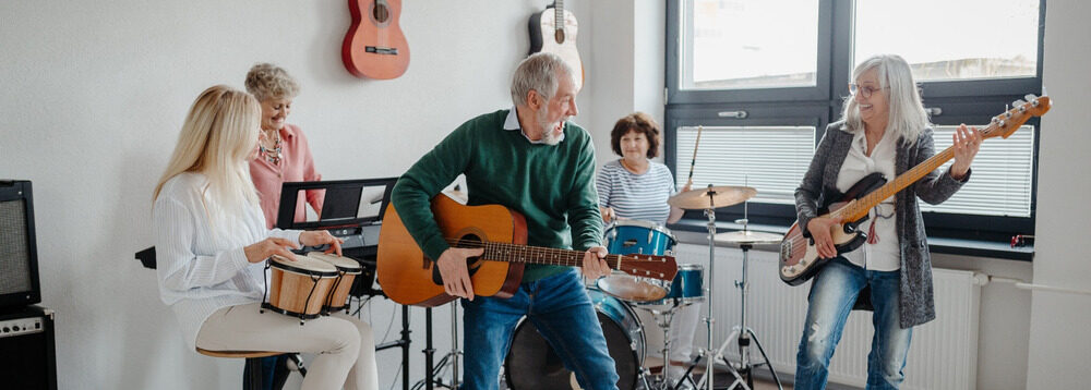 A group of people in their 50s playing musical instruments in a band.