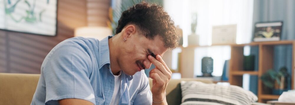 A stressed man with his head in its hand.