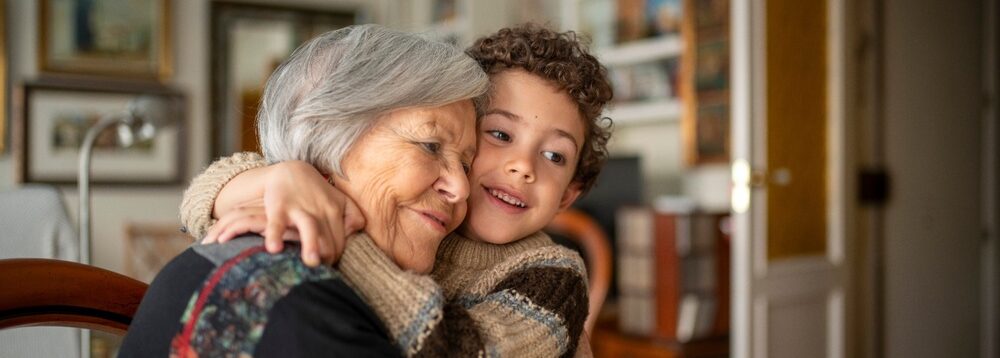 A woman hugging her grandchild.