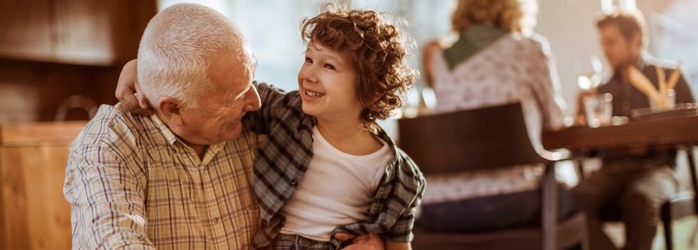 Grandfather hugging his grandchild.