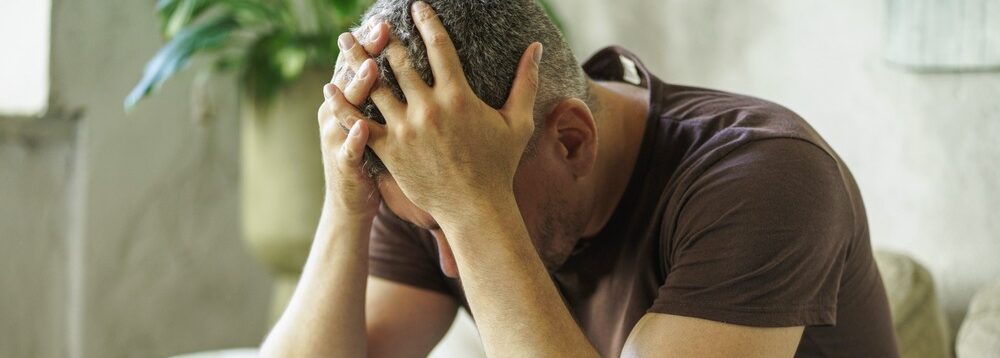 A man with his head in his hands.