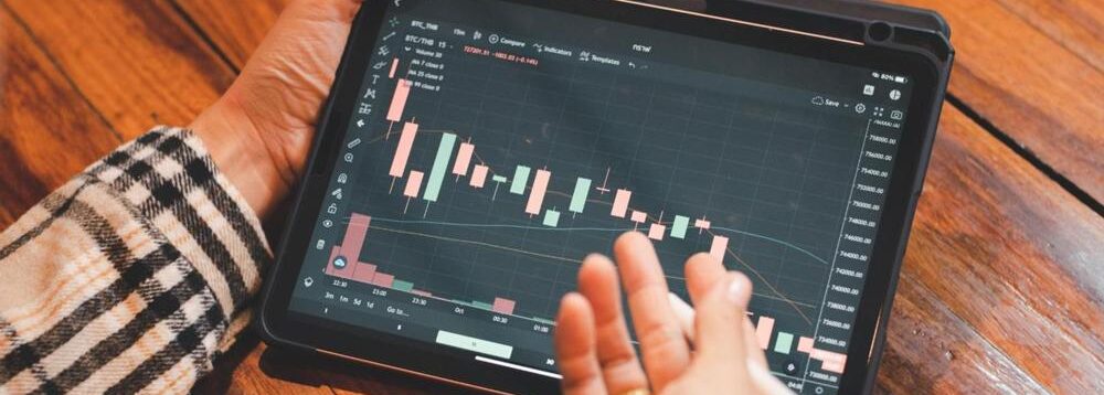 A person looking at investment performance on a tablet.