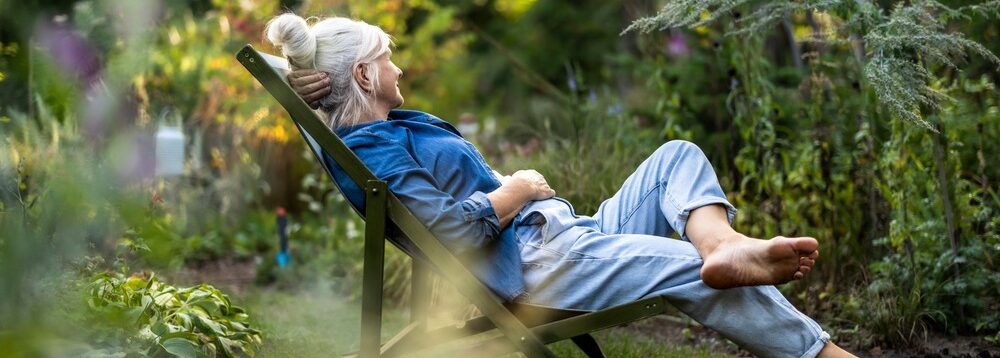 A woman relaxing in a garden.