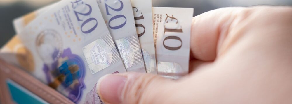 Someone taking money out of a wallet.