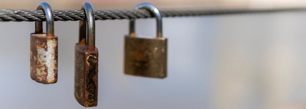 Three padlocks on a chain.
