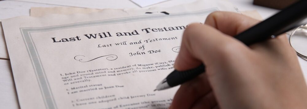 A person signing a will.