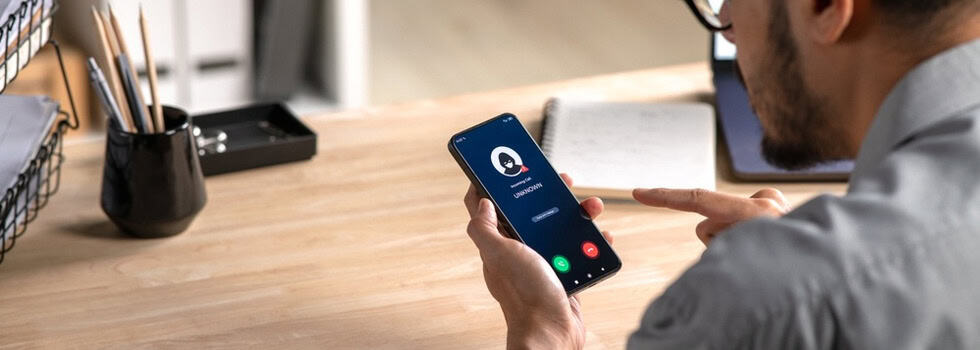 A man receiving a call from an unknown number.