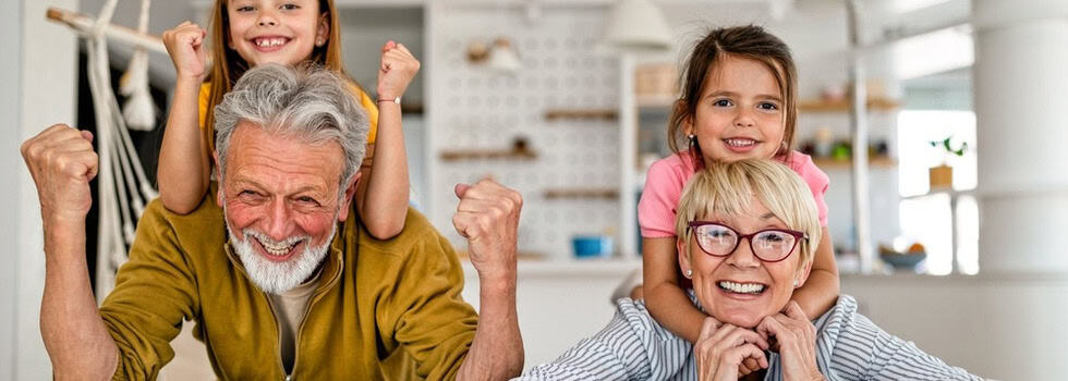 Grandchildren and grandparents having fun together in their kitchen
